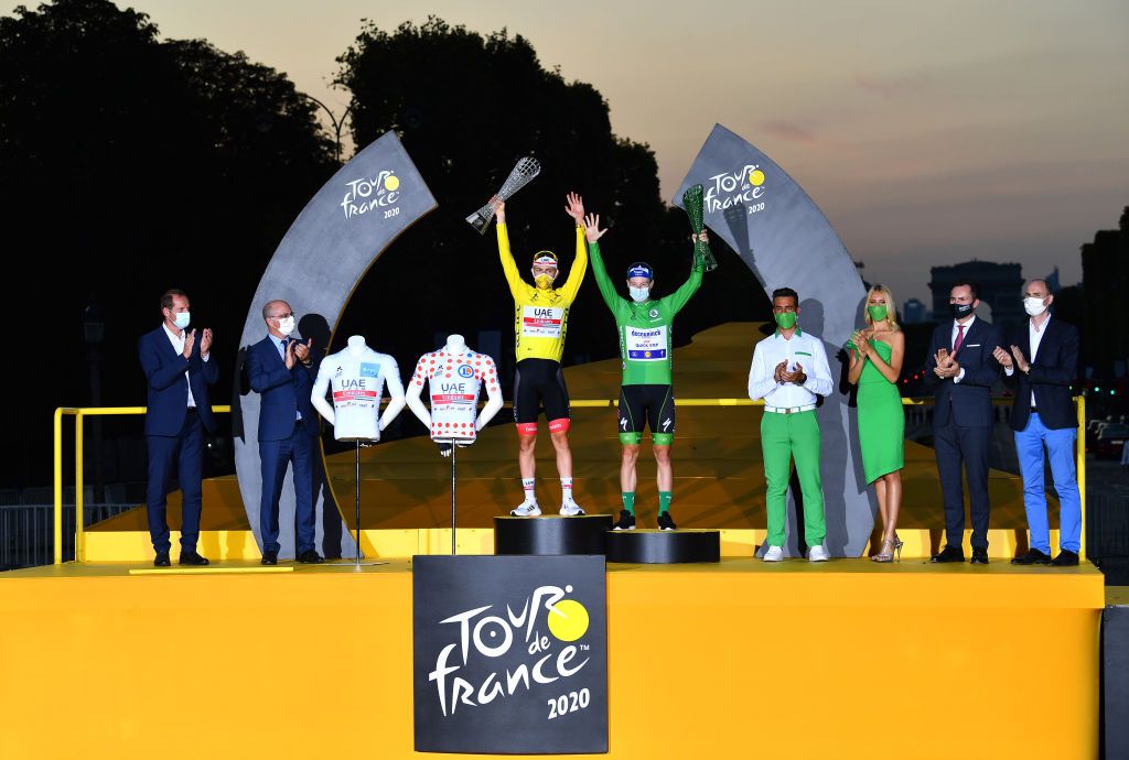 PARIS FRANCE SEPTEMBER 20 Podium Tadej Pogacar of Slovenia and UAE Team Emirates Yellow Leader Jersey White Best Young Rider Jersey and Polka Dot Mountain Jersey Sam Bennett of Ireland and Team Deceuninck QuickStep Green Points Jersey Celebration Trophy during the 107th Tour de France 2020 Stage 21 a 122km stage from MantesLaJolie to Paris Champslyses TDF2020 LeTour on September 20 2020 in Paris France Photo by Stuart FranklinGetty Images