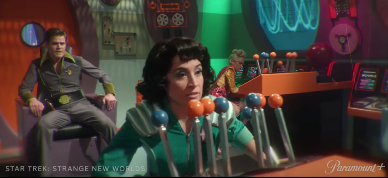 three retro-era sci-fi characters on a colorful spaceship set