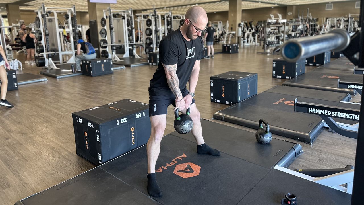 Miller Latvala, personal trainer, demonstrates a sumo squat with kettlebell