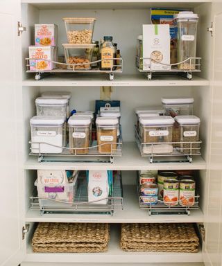 Pantry with deep pullout shelves and labeled foods and canned goods from Composed Living