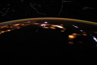 This image captured from the International Space Station in 2012 by NASA astronaut Don Petit, shows a Lyrid meteor streaking through the night sky. NASA astronomer Bill Cooke mapped the meteor to the star field — the white constellations at the top of the image.