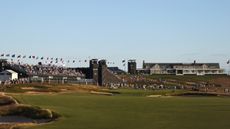 A view of the 16th green and the clubhouse in the background at Shinnecock Hills Golf Club