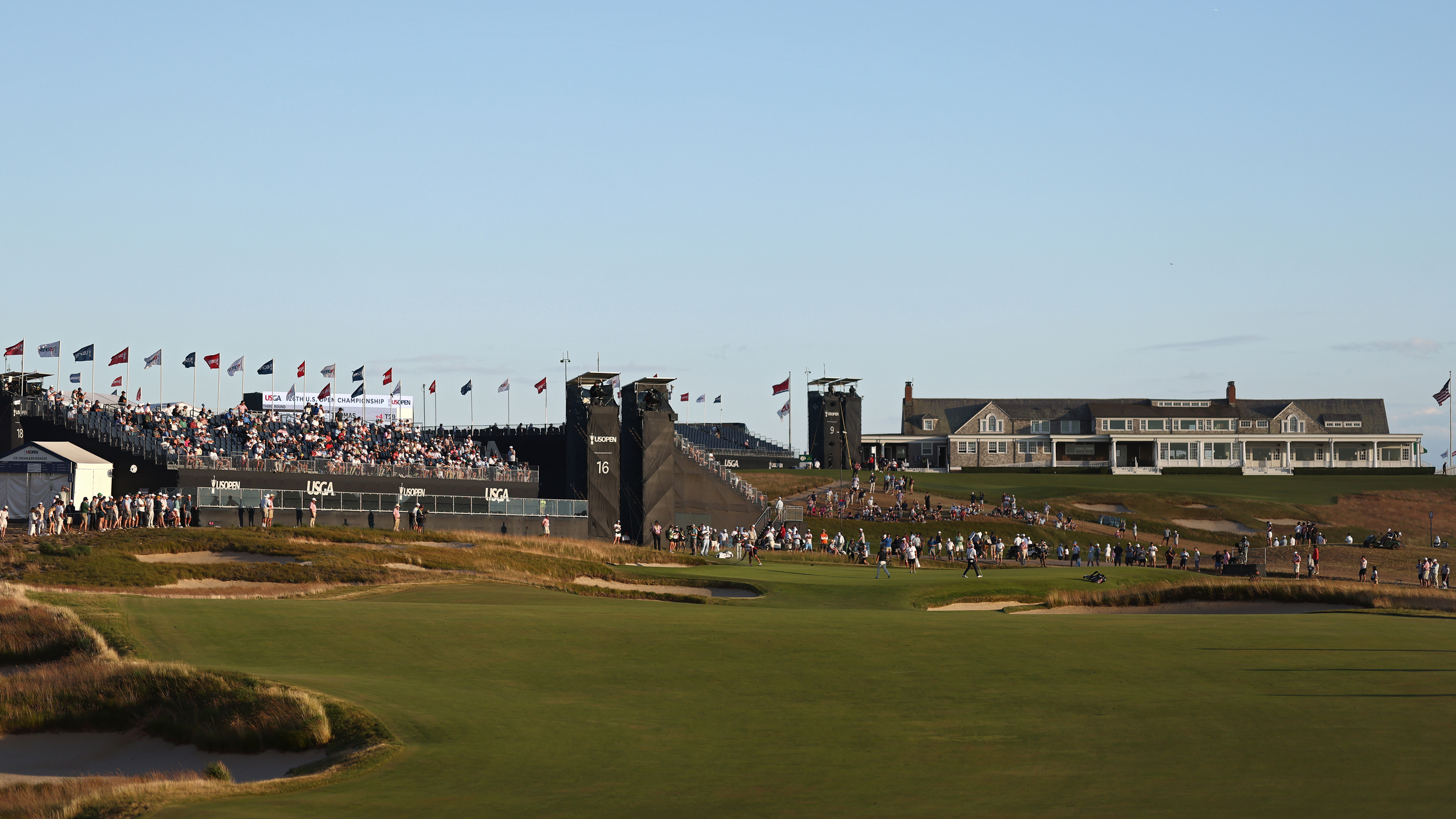 A view of the 16th green and the clubhouse in the background at Shinnecock Hills Golf Club