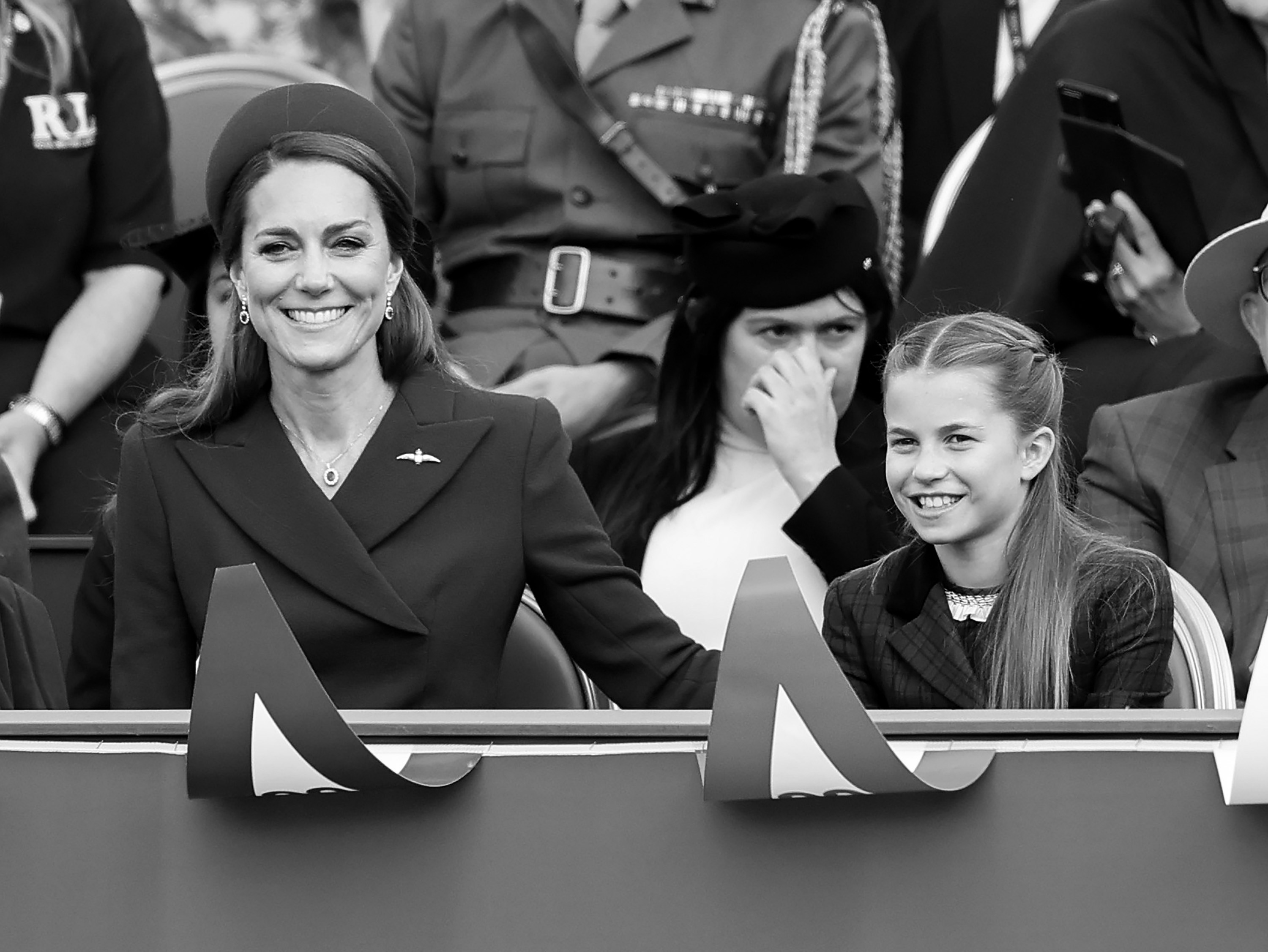 A black and white photo of Princess Kate and Princess Charlotte smiling at the VE Day parade 2025