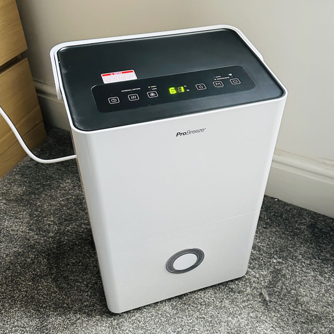 The Pro Breeze 30L High Capacity Smart Dehumidifier review being tested in a room with grey carpet