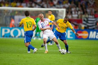 Zinedine Zidane of France and Gilberto Silva and Juninho Pernambucano of Brazil in action during the World Cup Quarter Final match between France (1) and Brazil (0) at the Commerzbank Arena on July 01, 2006 in Frankfurt, Germany.