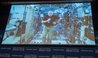 On Sept. 14, 2015, astronaut Scott Kelly participated via video link from the International Space Station in a discussion with astronaut Terry Virts and Kelly's twin brother, retired astronaut Mark Kelly, at the National Press Club in Washington.