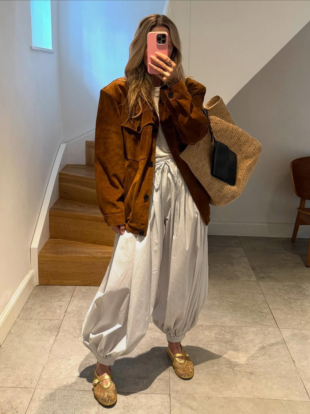 @denisechristensenbc wears balloon pants, brown suede jacket and gold shoes