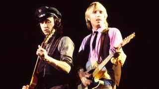 Mike Campbell (left) and Tom Petty (1950 - 2017), both of the group Tom Petty and the Heartbreakers, play guitar as they perform onstage at Nassau Coliseum, Uniondale, New York, March 31, 1983