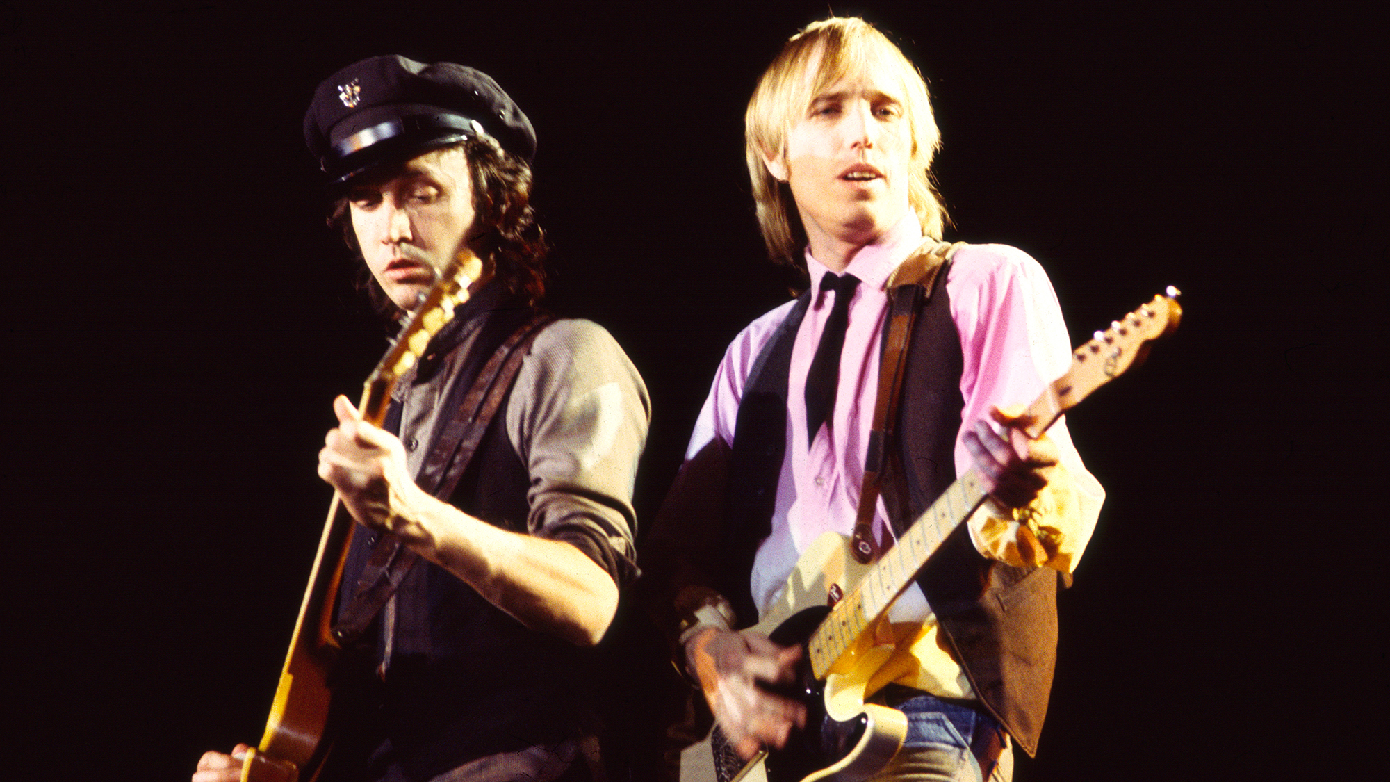 Mike Campbell (left) and Tom Petty (1950 - 2017), both of the group Tom Petty and the Heartbreakers, play guitar as they perform onstage at Nassau Coliseum, Uniondale, New York, March 31, 1983