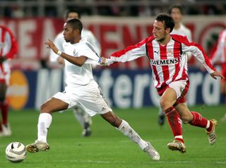 Olympiacos midfielder Pantelis Kafes (right) holds the shirt of Real Madrid forward Robinho during a Champions League clash in December 2005.