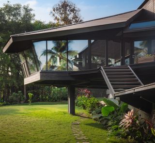 The kitchen and dining areas are cantilevered out above the garden