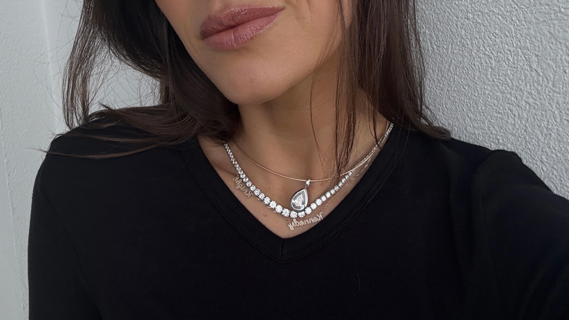 Kira Mackenzie Jackson wearing a black shirt with layered diamond necklaces