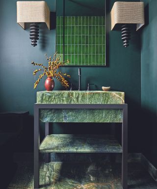 Dark green bathroom vanity with dark wall behind