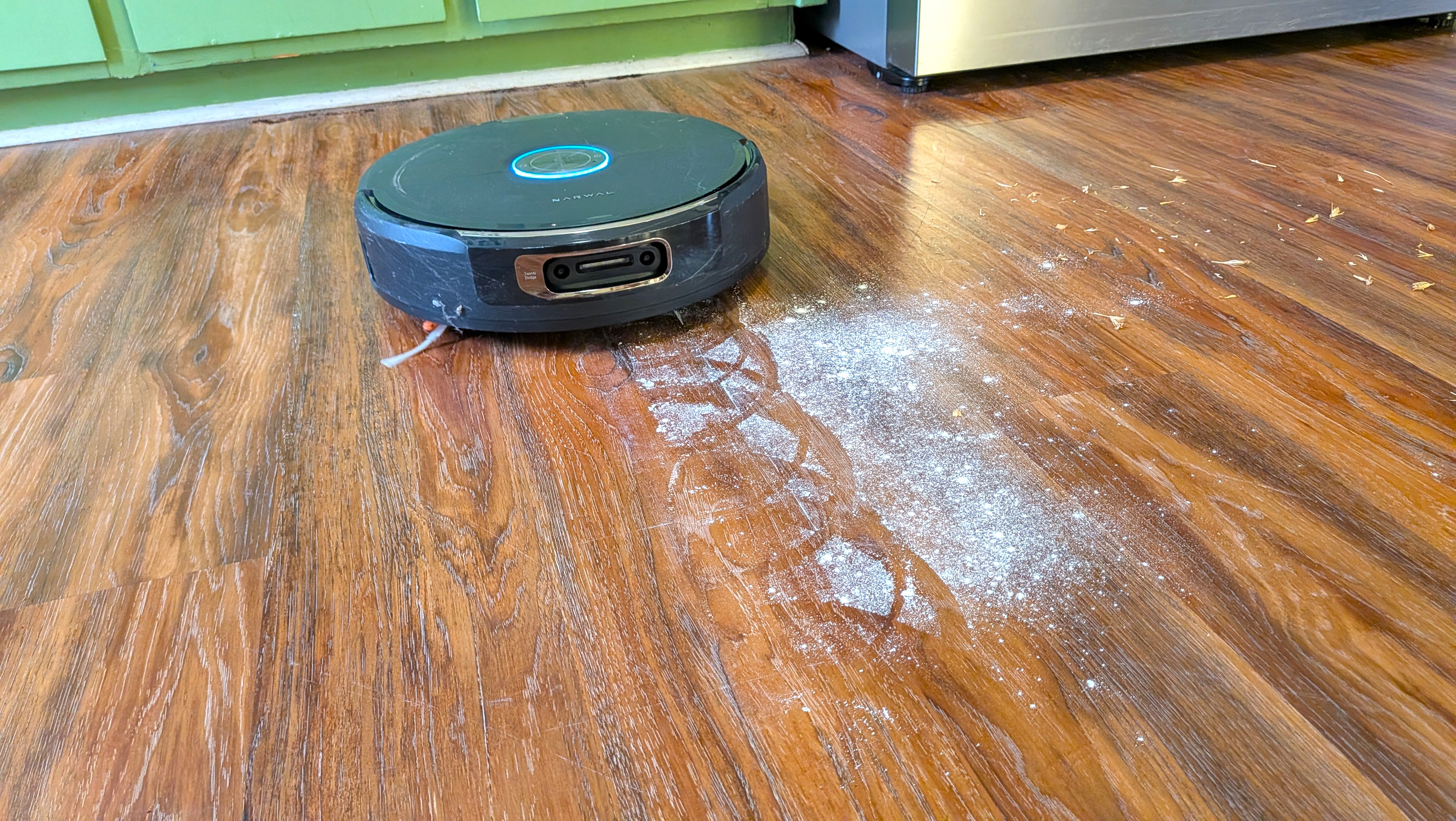 Narwal Flow 2 robot vacuum cleaning flour from hard floor