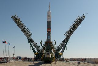 The arms of a mobile gantry close around the Soyuz rocket that will launch three Expedition 61 crewmembers to the International Space Station, shortly after the rocket was erected on the pad at the Baikonur Cosmodrome in Kazakhstan. On Wednesday (Sept. 25), this rocket will launch the Soyuz MS-15 spacecraft with NASA astronaut Jessica Meir, Russian cosmonaut Oleg Skripochka and Hazza Ali Almansouri, the first astronaut of the United Arab Emirates.