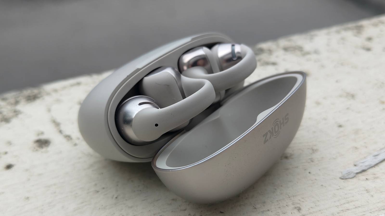 The Shokz OpenDots One on a white windowsill