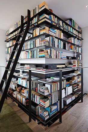 An extraordinary two-storey high bookshelf pierces the two lower levels