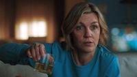 Rhea Seehorn as Carol Sturka holding a glass in Pluribus