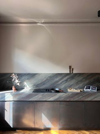 A kitchen with light gray countertop