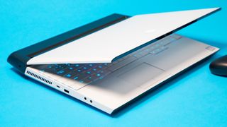 A 17-inch Alienware laptop, one of the best 17-inch laptops, on a blue surface