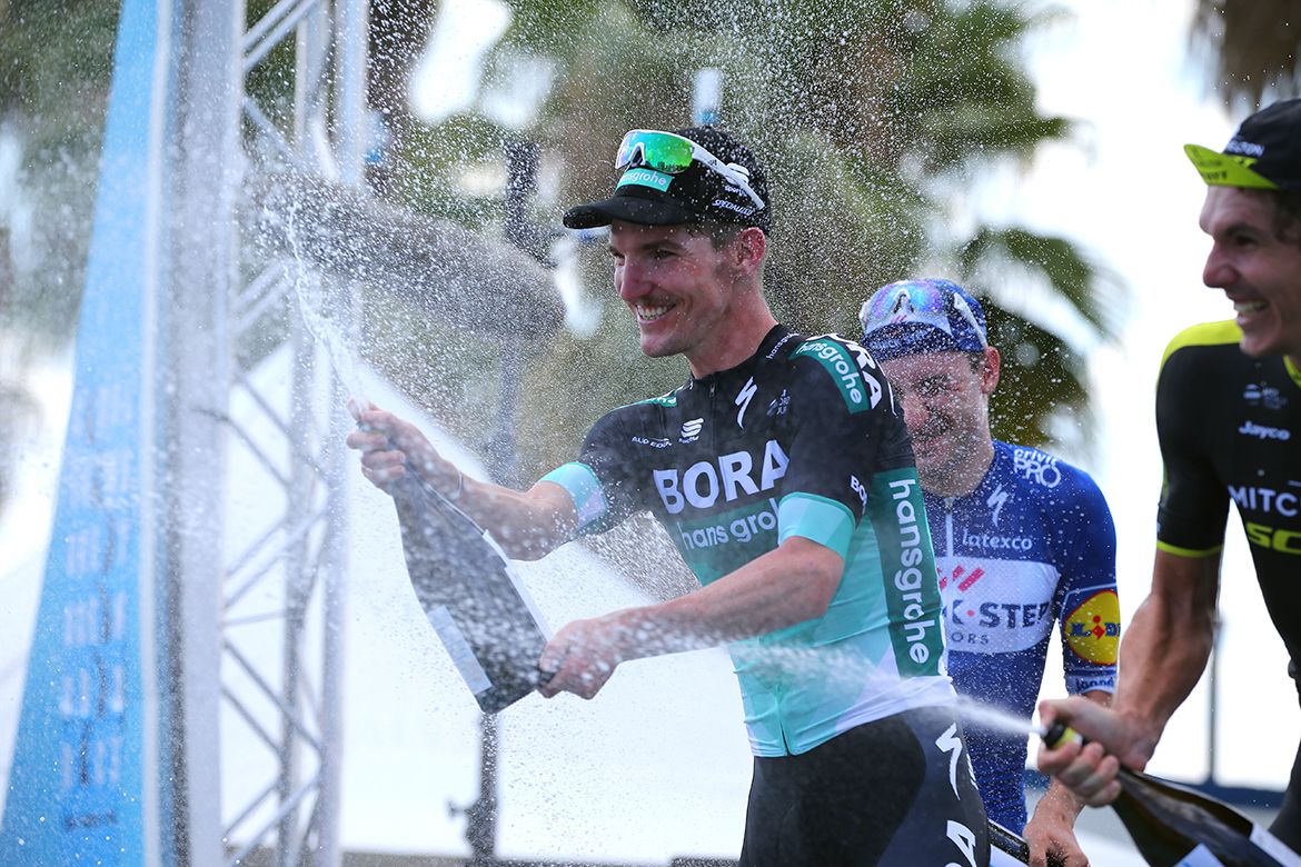 Jay McCarthy sprays the champagne on the podium