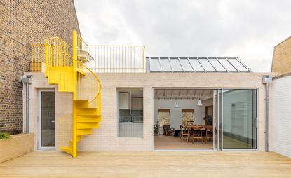 East London apartment revived by sparky yellow staircase