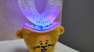 Review photo of the AutoBrush Sonic Pro for Kids with both the blue and red LEDs turned on.