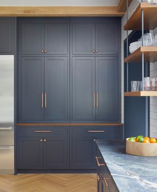 Navy Shaker-style kitchen with copper handles and blue-hued marble