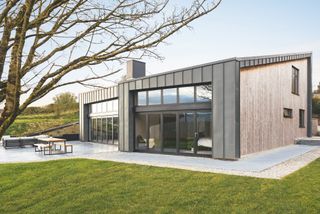 timber and zinc cladding in self build with lots of glazing