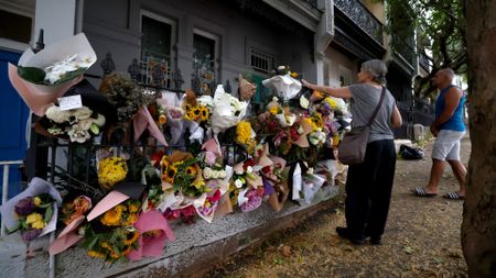 Floral tributes left by mourners are seen outside the shared residence of entertainment journalist Jesse Baird in the Sydney suburb of Paddington on 27 February 2024