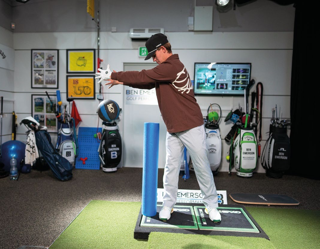 Amateur golfer, Benjamin, demonstrating the foam roller drill to banish the reverse spine angle from his golf swing