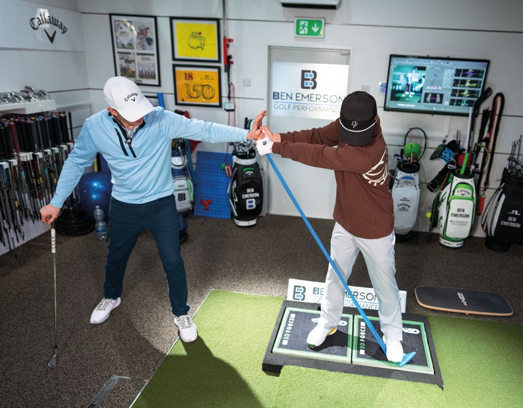Ben Emerson using a band to help Benjamin rid his reverse spine angle in a lesson