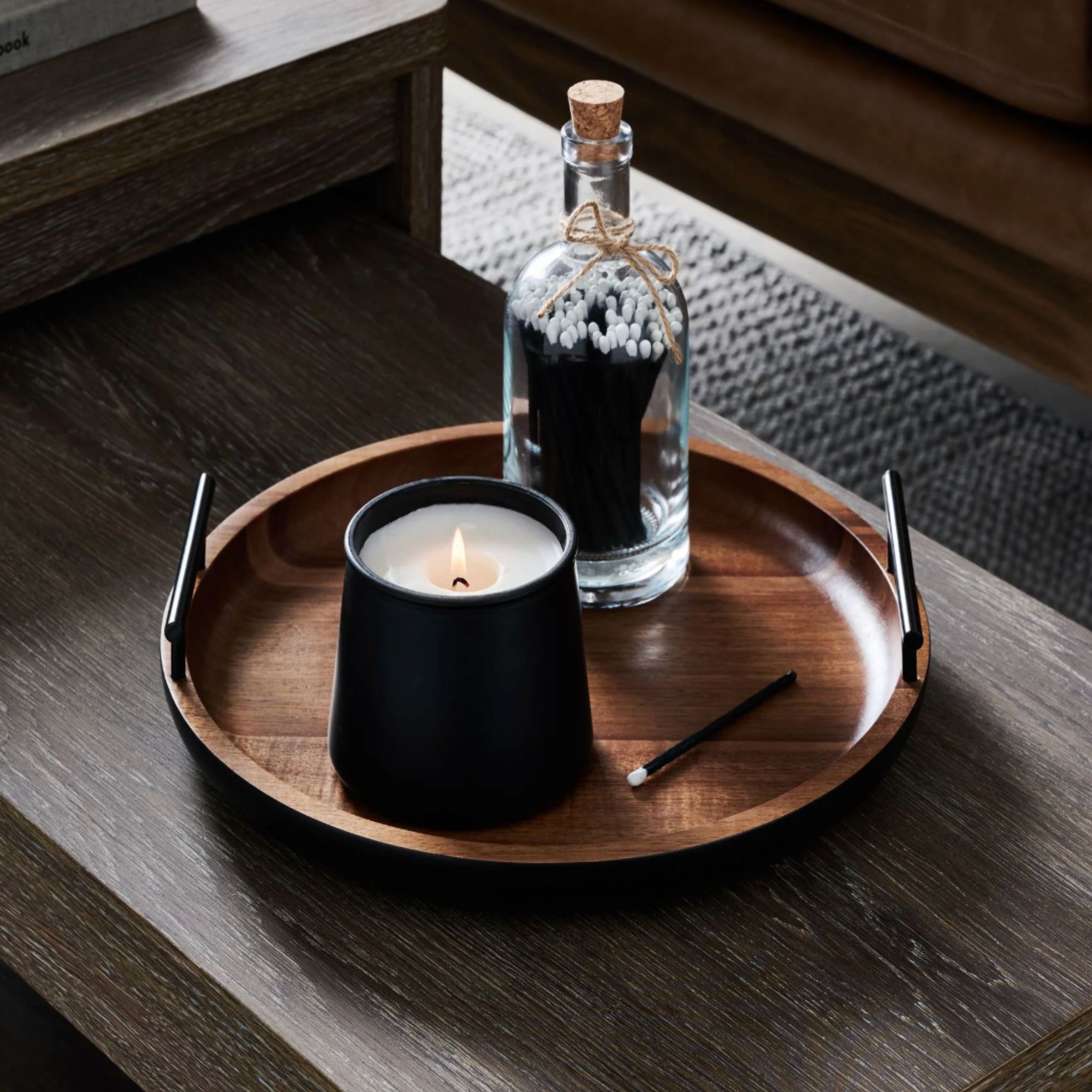 Dark wood decorative tray with a candle and matches on top