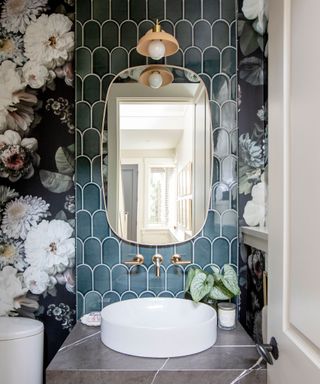 Powder room with floral wallpaper, mirror, plant and sink