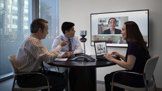A group of people in a video conference meeting.