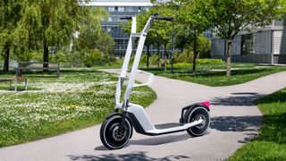 Concept art showing a BMW Clever Commute e-scooter in a park