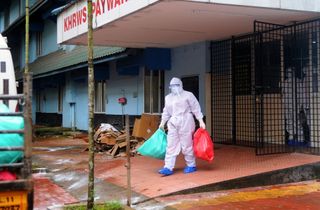 A health official stands outside the Kozhikode Medical College Hospital ward, which has been converted into a Nipah virus isolation ward on September 06, 2021 in Kozhikode, India.