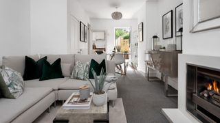 Small white living room with grey corner sofa made to fit perfectly to show how to make a small living room look bigger