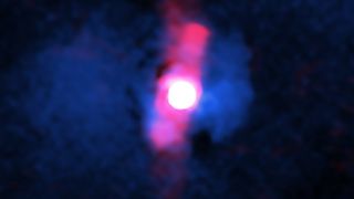 A composite image of the quasar H1821+643, with X-ray data from Chandra in blue and radio wavelength data from the Very Large Array in red showing the lobes of the radio jets, which are aimed almost directly at us.