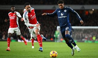 Marcus Rashford of Manchester United is challenged by William Saliba of Arsenal