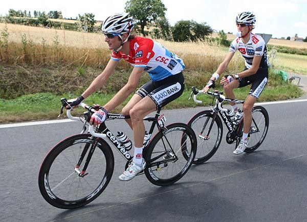 The Schleck brothers give some room to the riders in the feed zone.