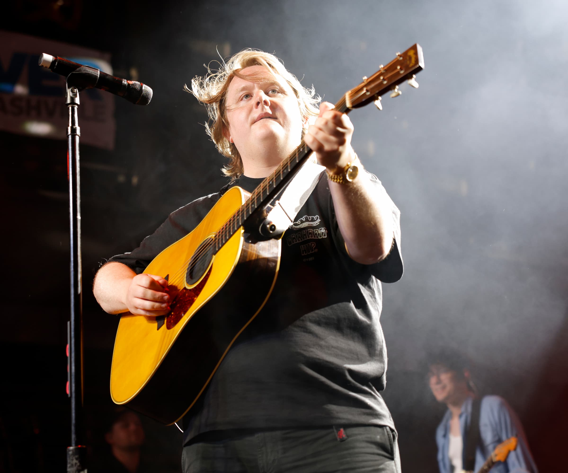 Lewis Capaldi on stage with a guitar