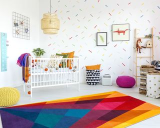 Gender neutral nursery ideas: Multicolored rainbow themed bedroom by Sonya Winner Rug Studio