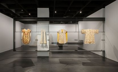 Costume Institute exhibition space by Diller Scofidio + Renfro featuring four items on display. 