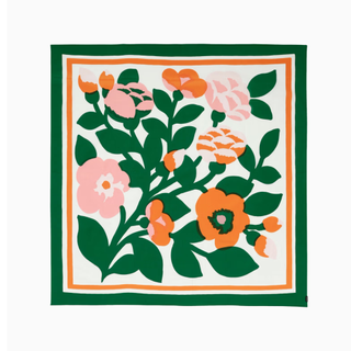 table cloth with large floral pattern in green, pink, orange, and white