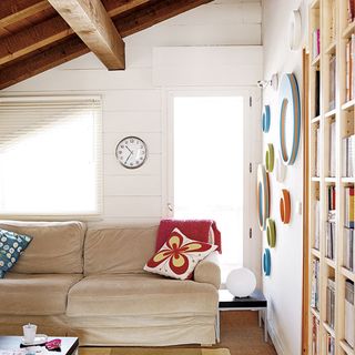 attic room with white wall and sofa