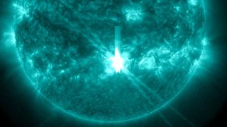 close up view of the sun shows the massive x class solar flare erupting as the sunspot region points straight at Earth.