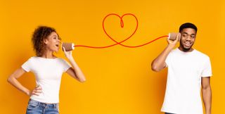 Couple with can phone on orange background