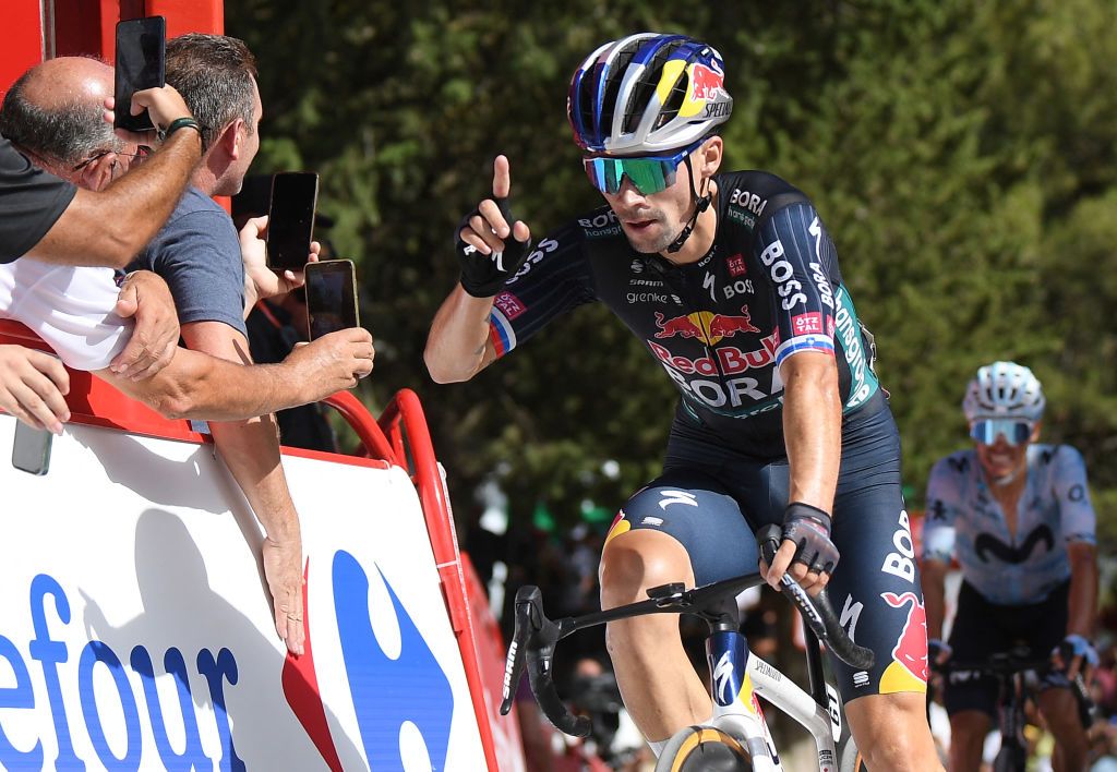 Team Bora's Primoz Roglic celebrates crossing the finish in first place, followed by Team Movistar's Enric Mas (R) at the end of the stage 8 of La Vuelta a Espana cylcing tour, a 159 km race between Ubeda and Cazorla, on August 24, 2024. (Photo by Jorge GUERRERO / AFP)
